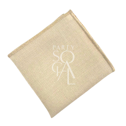 NAPKIN BLEACHED SAND W/ LINE featuring a stitched logo, shown as a white square object, ideal for events or dinners, available for personalization.