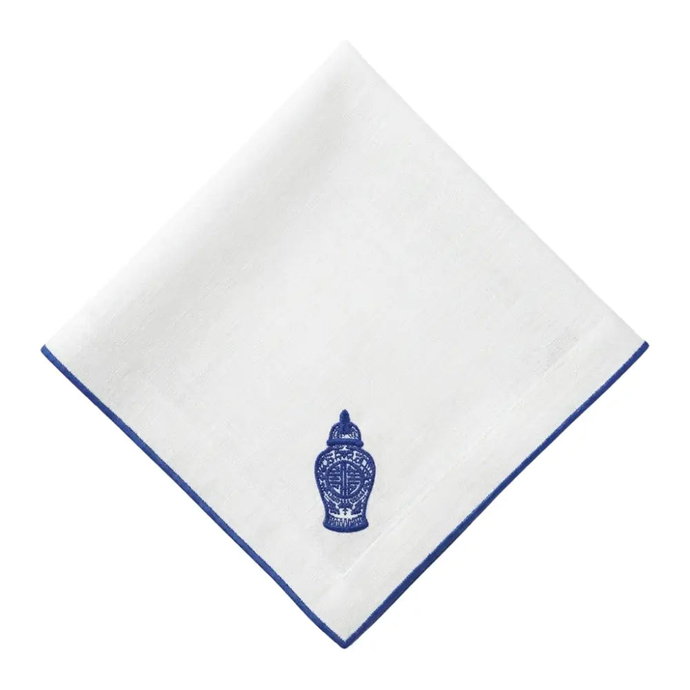 Blue Chinoiserie Pure Linen Dinner Napkin folded with blue piped edge and ginger-jar embroidery; ideal for elegant table settings at special events.