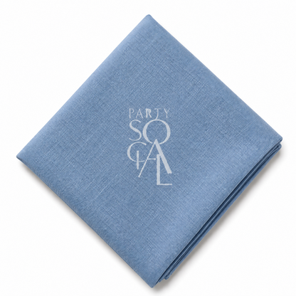 A square Blue Jeans linen napkin displayed diagonally on a clean white background.
