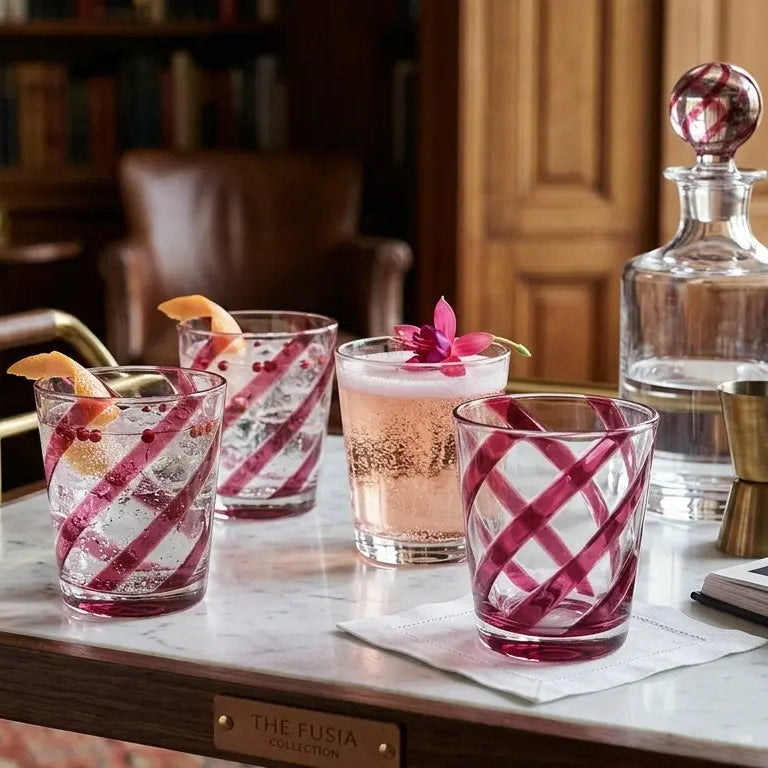 Cocktails in glasses with a checkered pattern on a table in a cozy room.