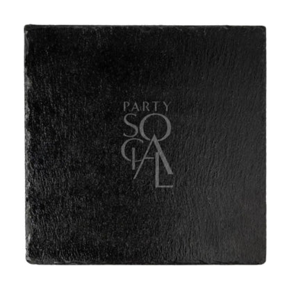 CHARGER GREY SLATE: A sophisticated grey slate charger, perfect for elegant table settings at events, embossed with “PARTY SOCIAL” branding in the center.