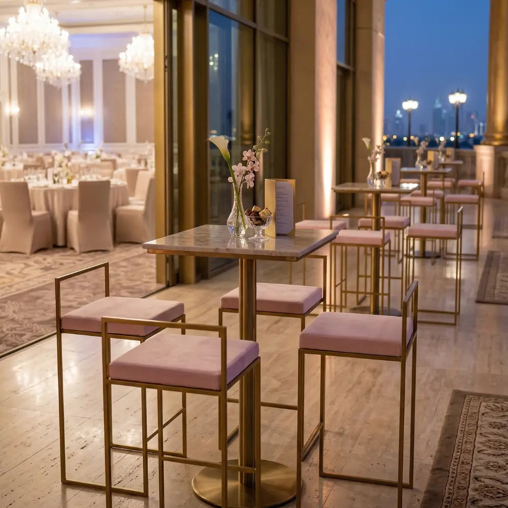 Elegant lounge area featuring CHARLOTTE CANTILEVER VELVET STOOL with blush upholstery and gold frames, enhancing the sophisticated ambiance of a wedding reception or cocktail event.