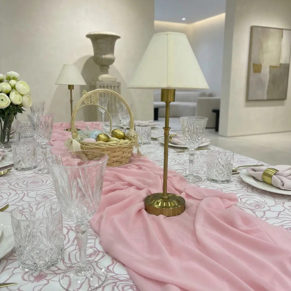Chiffon Table Runner elegantly drapes across a dining table with gold accents, crystal glassware, and decorative elements, perfect for special occasions by Party Social.