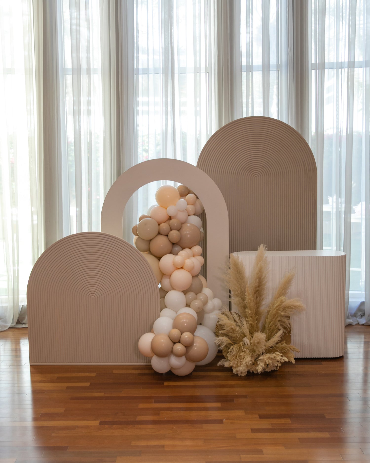 Mini Sand Molded Backdrop displayed indoors with white balloons, ideal for event photos, showcasing its use for parties and special occasions.