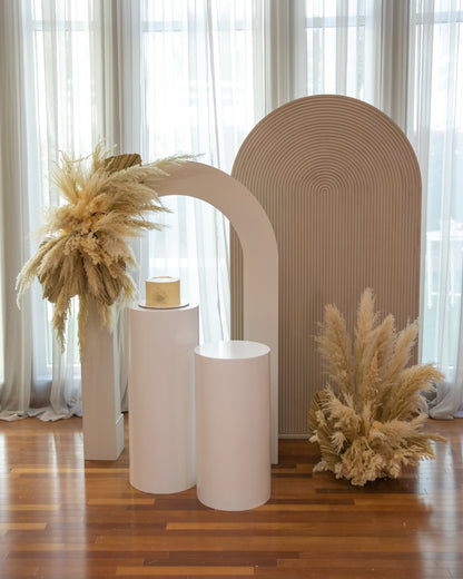 Sand Molded Backdrop displayed with dried flowers and vases, ideal for enhancing event decor as a photo backdrop or paired with arches and podiums.