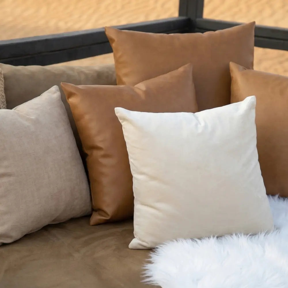 CUSHION COVER SATIN on a cozy sofa with varied throw pillows, showcasing premium satin fabric ideal for enhancing party or event seating arrangements.