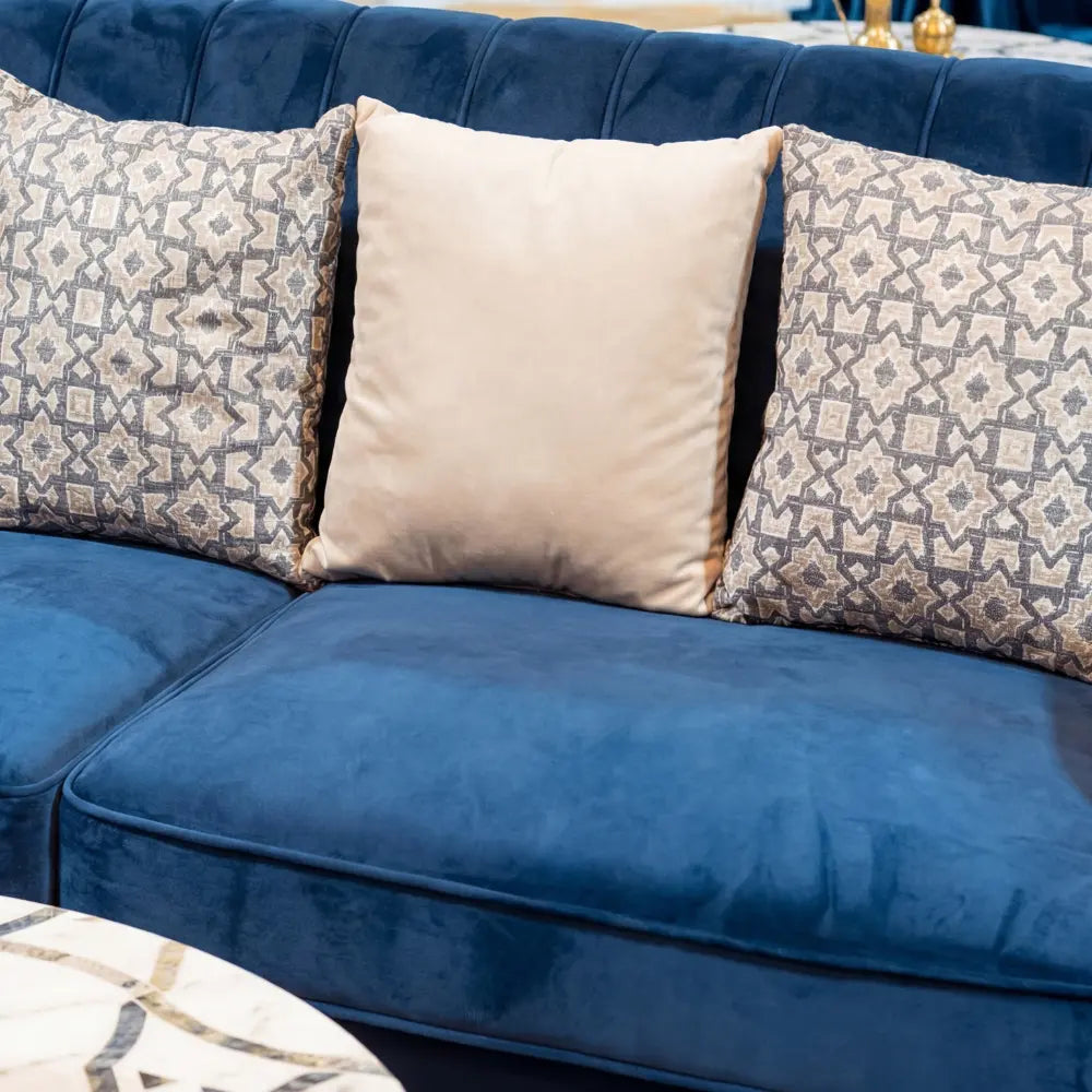 CUSHION GEOMETRIC PRINT on a deep-blue sofa, featuring gray-beige geometric pattern pillows, ideal for enhancing event decor with a touch of elegance.