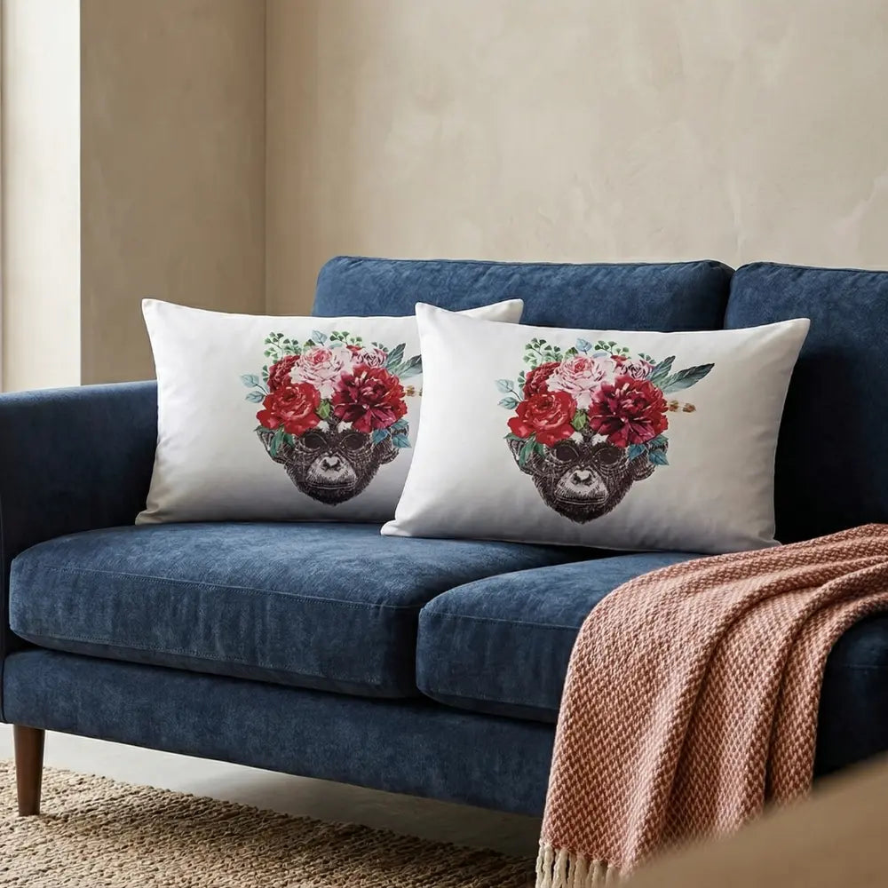CUSHION OFF WHITE W/ MONKEY FACE on modern blue sofa, perfect for event décor, features crowned chimpanzee print, includes filler, ready for immediate use.