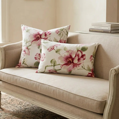CUSHION WHITE &amp; LARGE PINK FLOWERS on a neutral loveseat with floral throw pillows, emphasizing its ready-to-use feature for enhancing party or event decor.