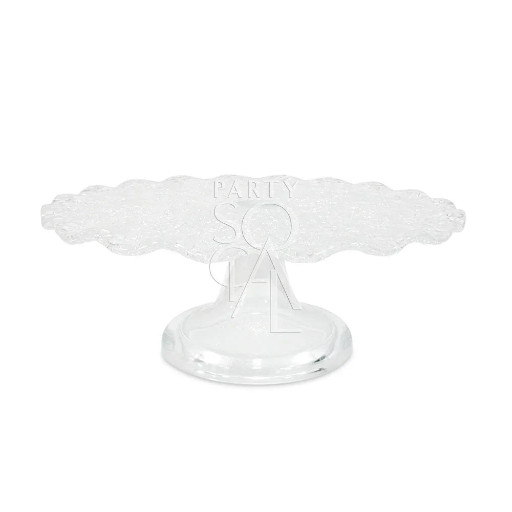 Clear cracked glass cake stand with a scalloped edge, ideal for showcasing cakes or as a centerpiece. Available in two sizes from Party Social.
