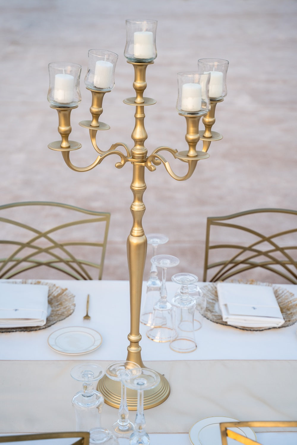 Candelabra on table with candles, showcasing an elegant design perfect for enhancing event decor. Candles are sold separately.