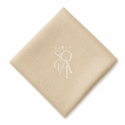 A square caramel cream linen napkin displayed diagonally on a clean white background.