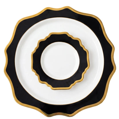 Black Lotus Collection: Three nested porcelain plates with white centers, black rims, and gold-trimmed scalloped edges, ideal for elegant dining settings.