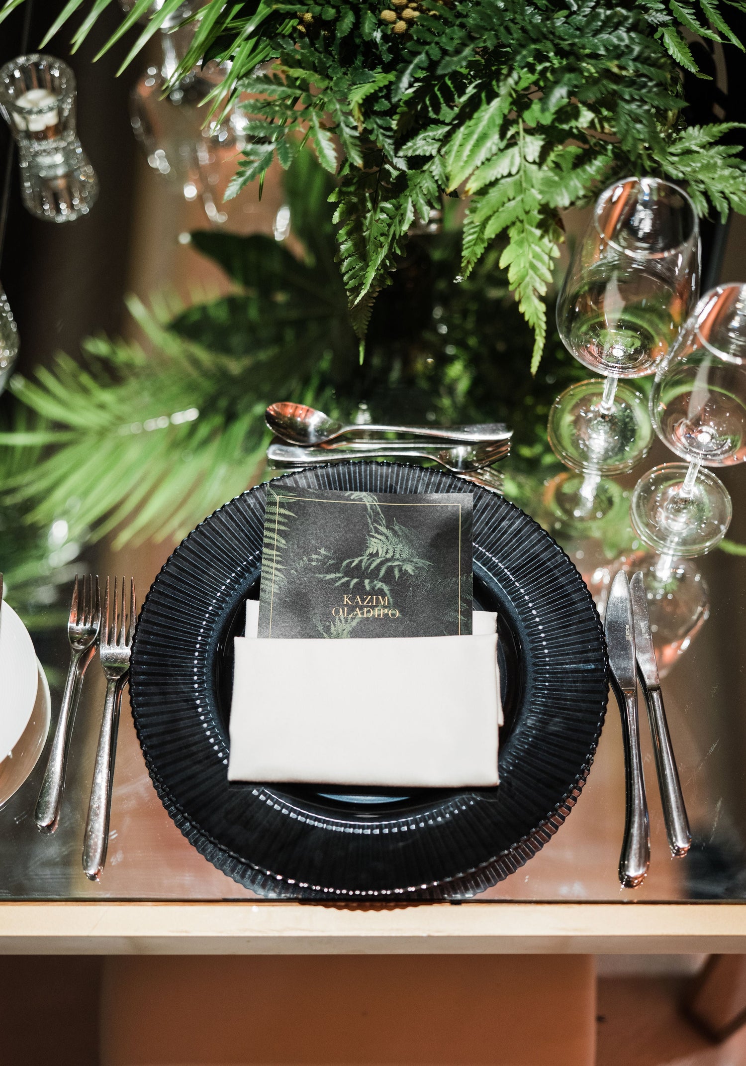 Charger Plate - Lined: A premium white lined glass charger plate elegantly set on a table with napkin and glasses, ideal for enhancing any event setting.