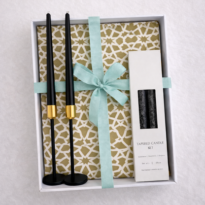 Noir &amp; Gold Signature Gift Box features black candlesticks with gold holders, black tapered candles, and decorative backing, ideal for elegant Ramadan celebrations.