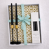 Noir & Gold Signature Gift Box features black candlesticks with gold holders, black tapered candles, and decorative backing, ideal for elegant Ramadan celebrations.