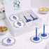 White gift box with blue-stemmed glasses and scalloped-edge coasters, featuring a ginger-jar motif, set for elegant home entertaining and Ramadan gifting.