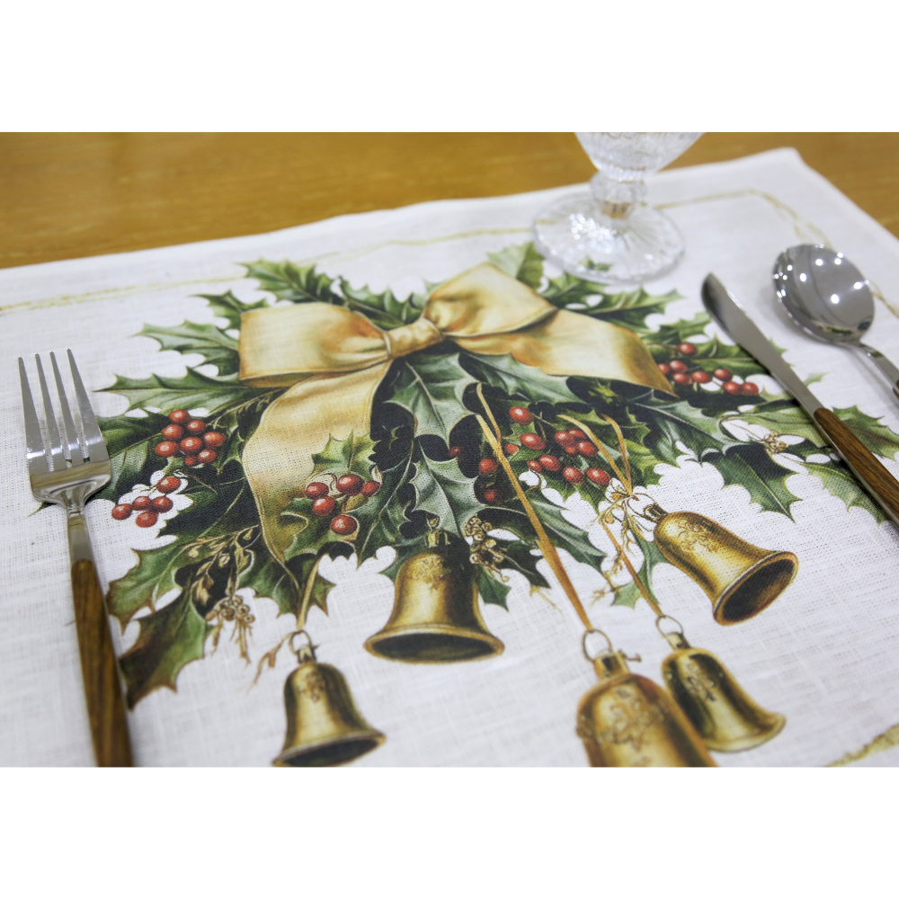 Golden Carol Linen Placemat featuring holly leaves, berries, and gold accents, set with stainless-steel flatware and glass goblet, enhancing your festive table setting.