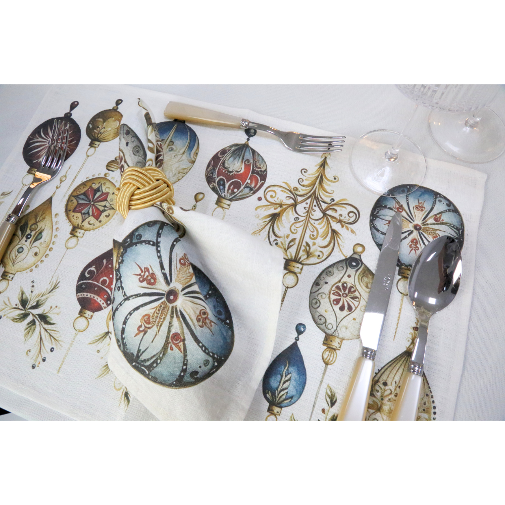 Jewel Cling Linen Placemat in a festive setting with matching napkin and gold-tone ring, complemented by ivory-handled flatware, enhancing holiday table elegance.