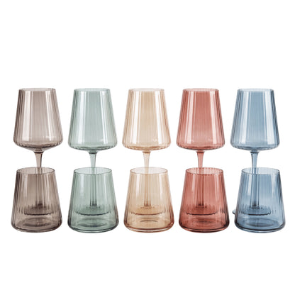 Six ribbed glass goblets in assorted translucent colors, including gray, green, peach, pink, and blue, arranged in two rows on a white background.