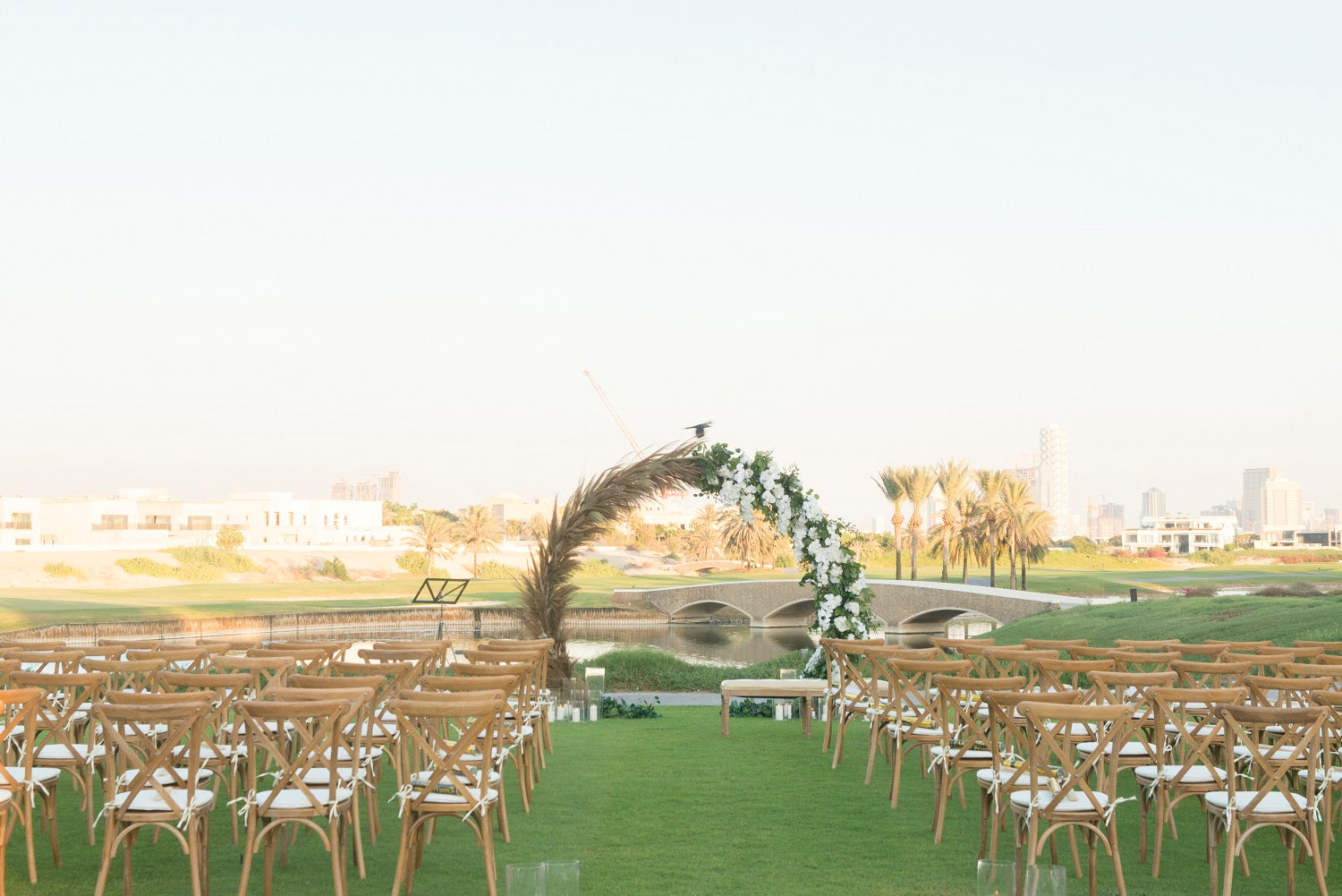 CROSSBACK CHAIR OAK WOOD arranged in a grassy outdoor wedding setting, showcasing its vintage design, ideal for events by Party Social.