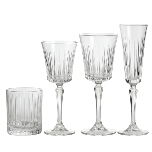 Crystal Paris Glassware Collection: Four ribbed glass pieces—tumbler, white wine, red wine glasses, and champagne flute—ideal for elegant gatherings and upscale events.