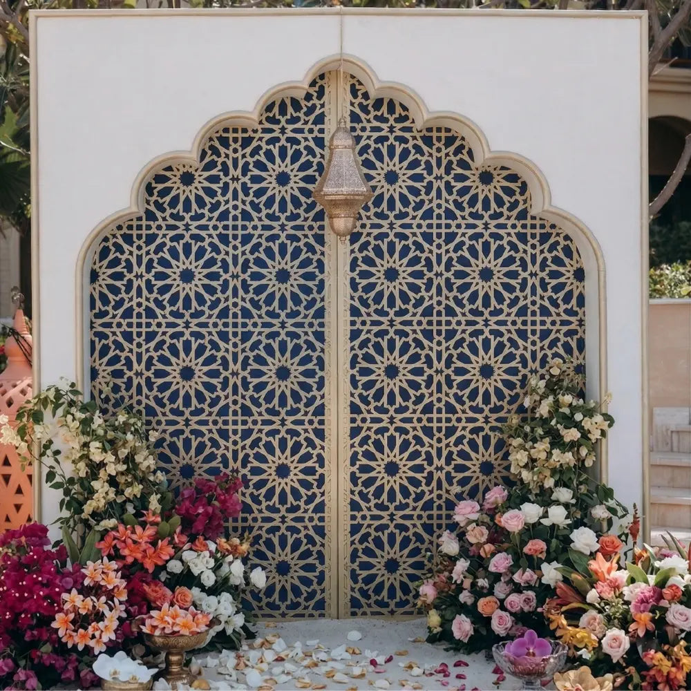 Curve Style Arch with intricate geometric pattern, adorned with floral arrangements and a metal lantern, perfect for enhancing event elegance and sophistication.