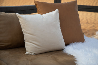 CUSHION COVER SATIN: A white satin cushion cover displayed on a brown couch, ideal for enhancing event decor with elegance. Available in various sizes.