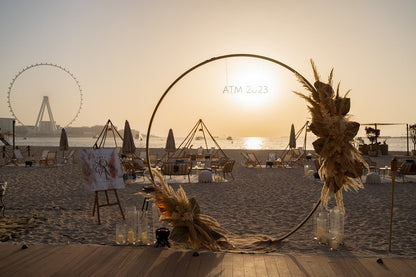 Round Gold Arch on a beach, ideal for events like weddings and parties, showcasing its versatile design for various occasions.