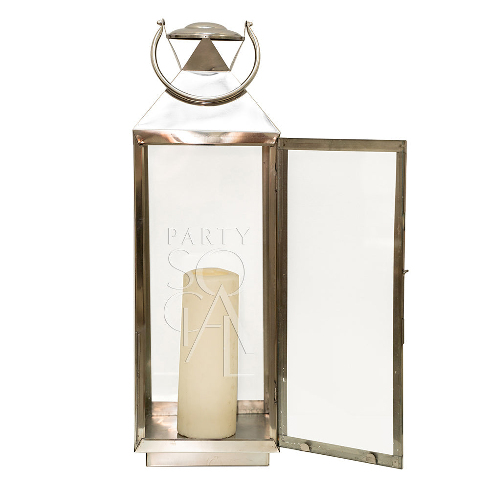 Silver lantern featuring a candle inside a glass frame, showcased as part of Party Social&