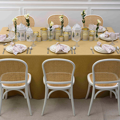 Desert Sand Collection: Elegant table setting with wicker chairs, tableware, and a floral centerpiece, ideal for Ramadan and Eid dining experiences, available for rental.