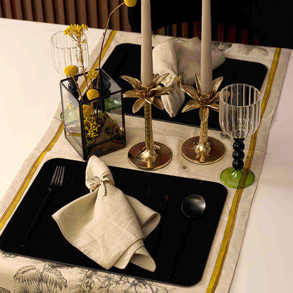 Simple Black Cutlery Set of 4 displayed on an elegantly set table with candles and napkins, enhancing a sophisticated table setup.