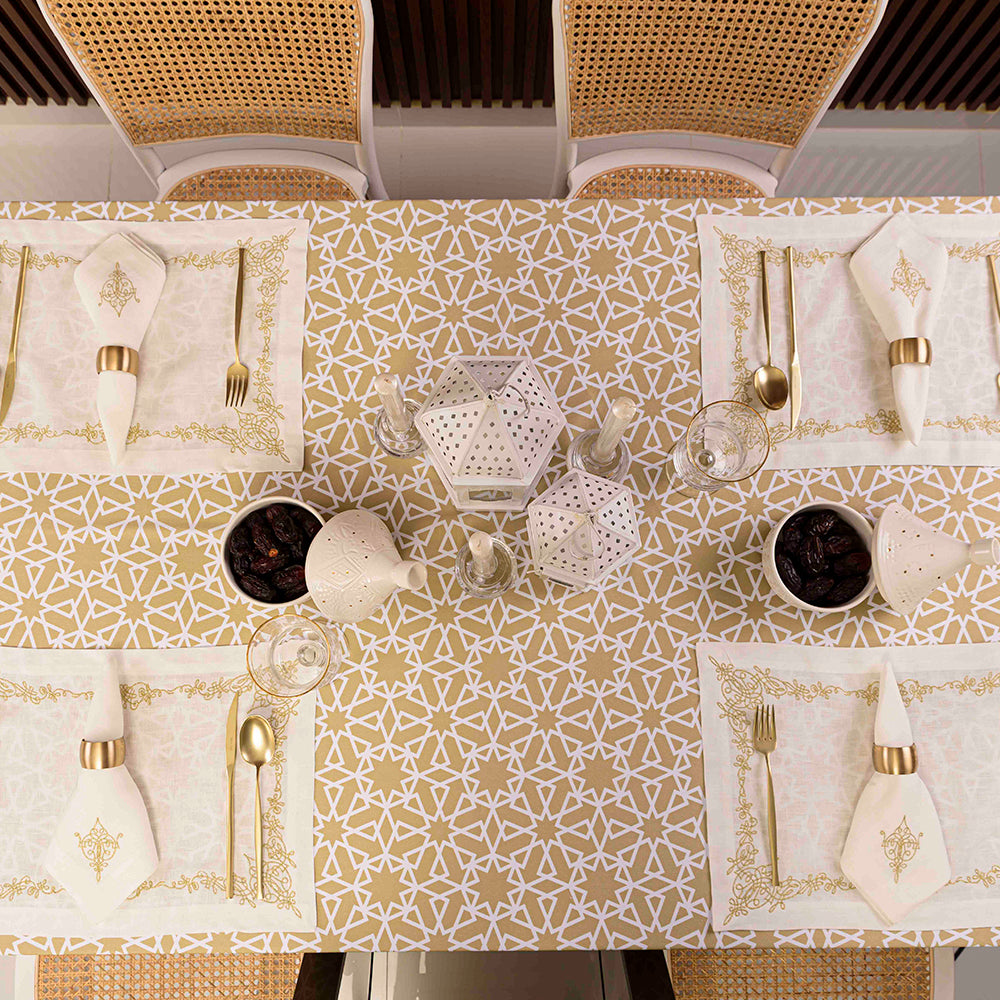 Geometric patterned table setting with elegant silverware and napkin, a bowl of dates, and a wicker surface.