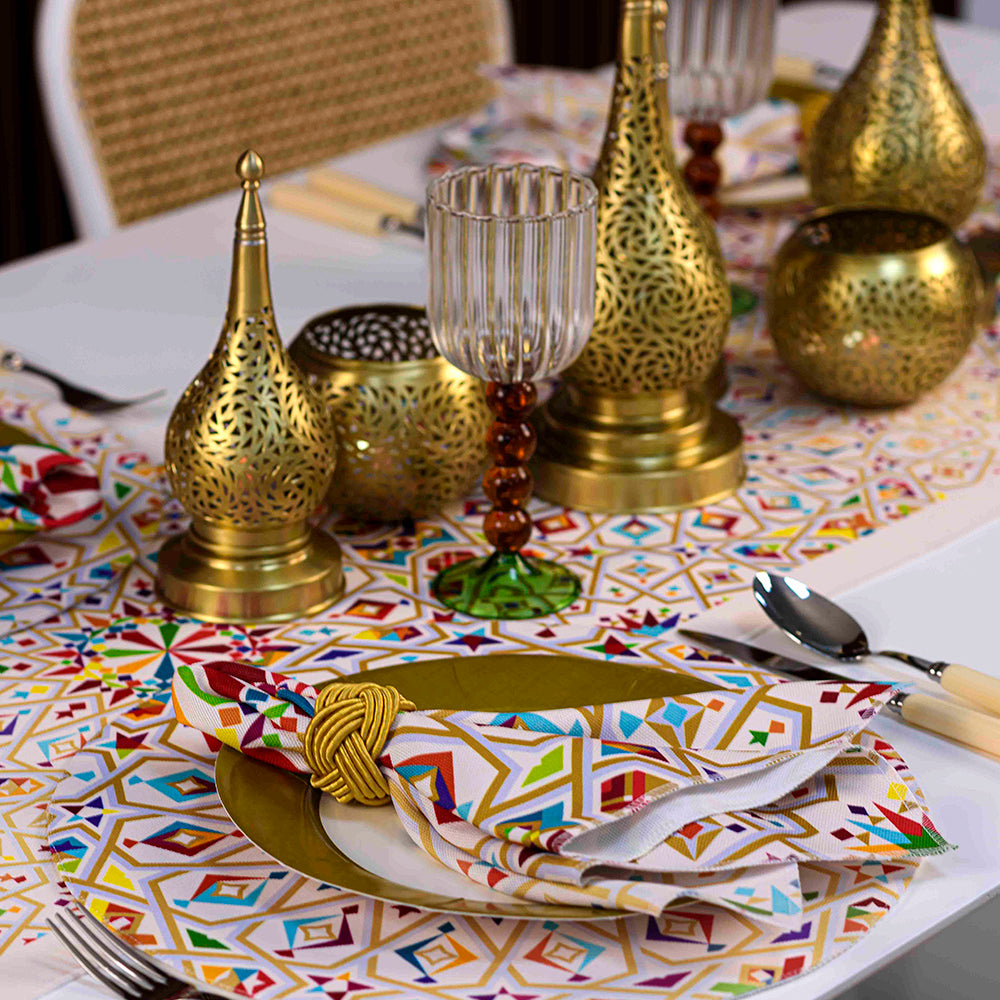 Arabesque Polyester Linen Napkin on table with plate, utensils, and gold vase.