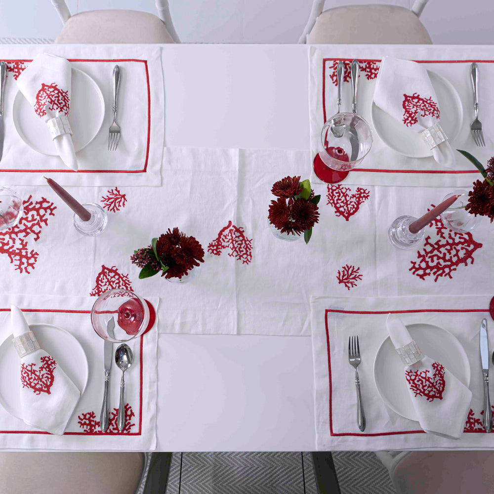Red Coral Pure Linen Runner on elegant table setting with tableware, flowers, and napkins.