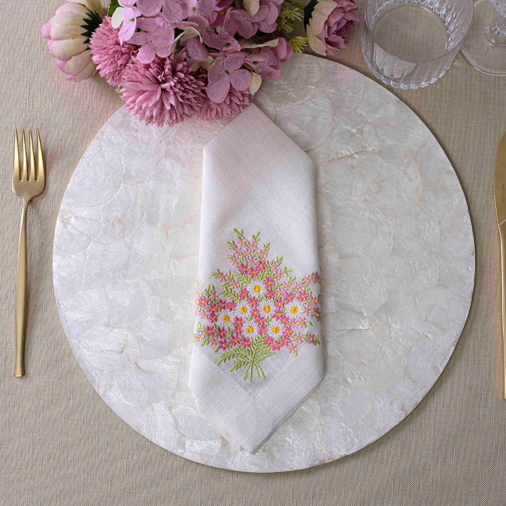 Daisy Pure Linen Dinner Napkin set with floral design and kitchen utensil.