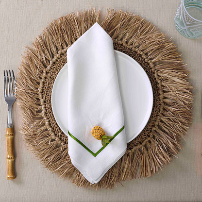 Round Woven Seagrass Placemat with fork and napkin on mat, glass close-up, pencil detail.
