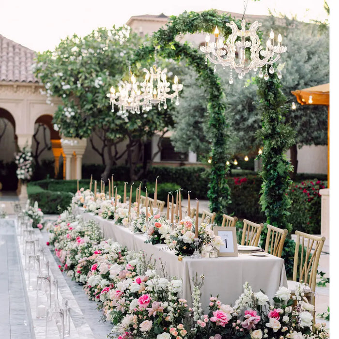 Garden wedding with florals, chandeliers and chairs