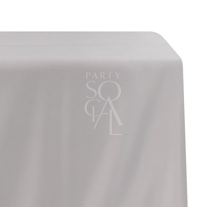 Rectangular satin tablecloth featuring a subtle logo, ideal for special occasions and events. Perfect for enhancing party or event decor.