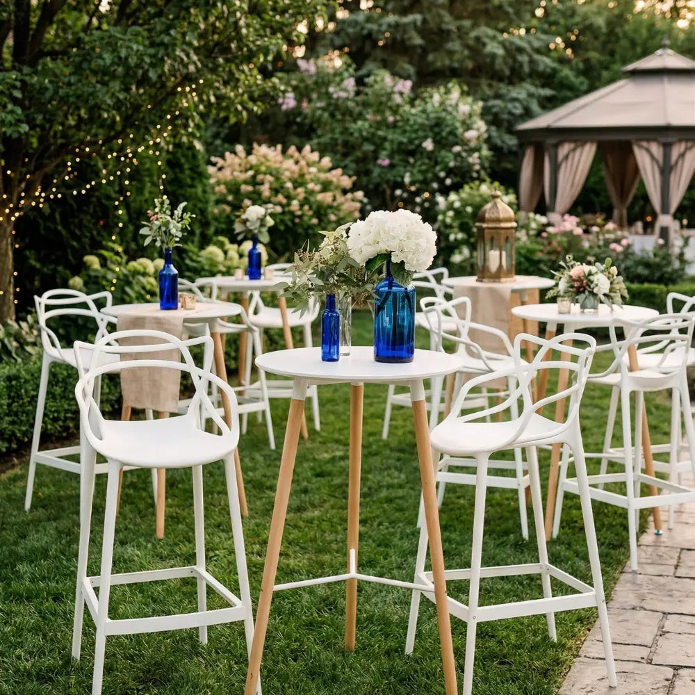 EAMES REPLICA COCKTAIL TABLE with white top and wood legs, set in an elegant outdoor event space with matching chairs and floral decor.