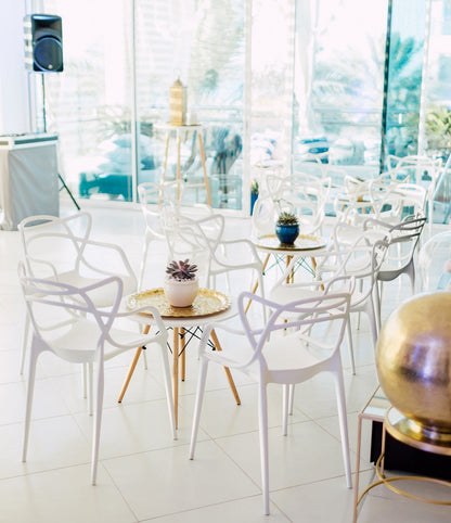 EAMES REPLICA COFFEE TABLE displayed in a modern setting, surrounded by white chairs, showcasing its suitability for events and home functions.