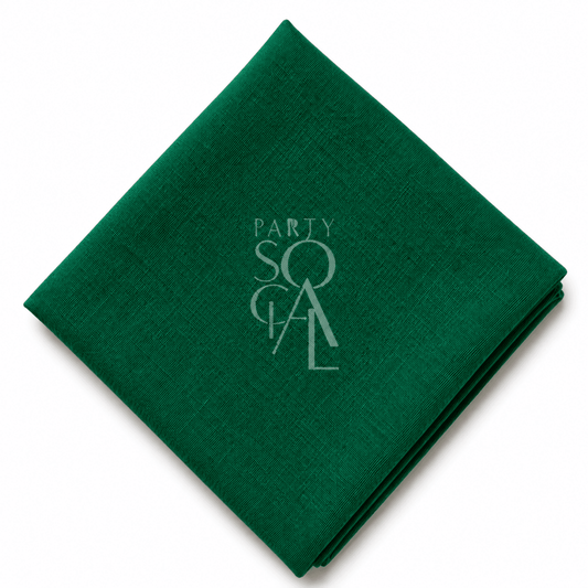 A square emerald linen napkin displayed diagonally on a clean white background.