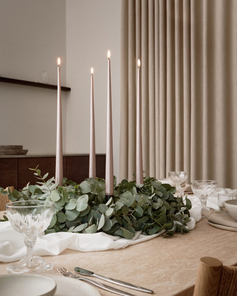 Tapered Smokeless and Dripless Gold Metallic Candles, 42cm, elegantly displayed on a table with eucalyptus wreath and tableware, creating a warm ambience.