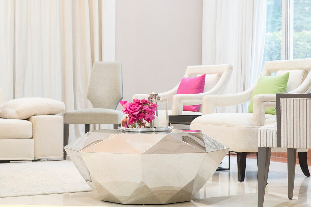 Mirrored silver coffee table in a stylish living room setting, featuring a diamond design, ideal for party and event occasions.