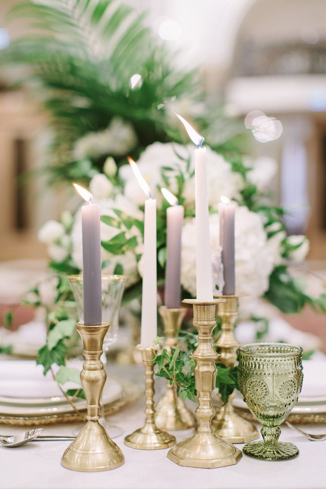 BRASS CANDLESTICKS SET OF 3 displayed as a centerpiece on a table, featuring matte brass finish, ideal for rustic or premium events.