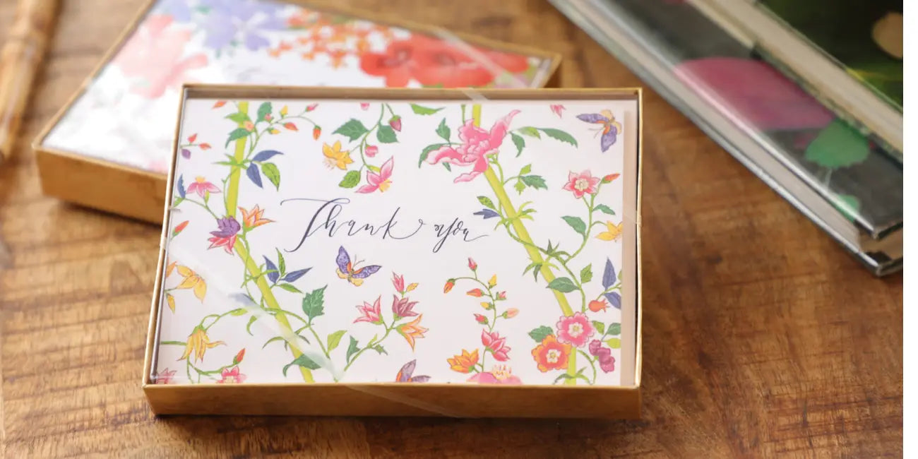 Floral card with 'Thank you' text on a wooden surface