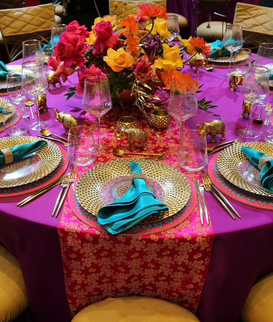 Brocade Table Runners elegantly adorn a dinner party setup, showcasing premium tableware with a floral centerpiece, ideal for elevating special event decor.
