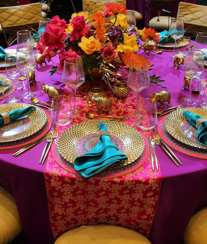 Brocade Table Runners elegantly adorn a dinner party setup, showcasing premium tableware with a floral centerpiece, ideal for elevating special event decor.