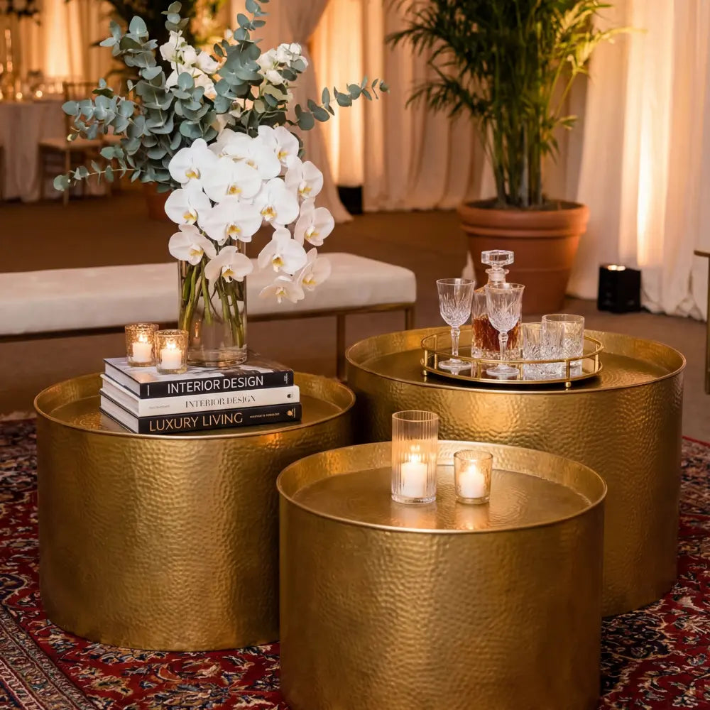 ALUMINIUM COFFEE TABLE set with elegant decor, including orchids and crystal glassware, on a patterned rug, creating a sophisticated party ambiance.