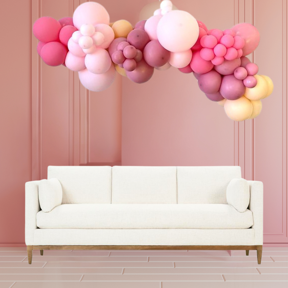 White couch adorned with a Customize Inflated Balloon Garland-2.5m, perfect for enhancing party decor with ease of hanging, ideal for events and celebrations.